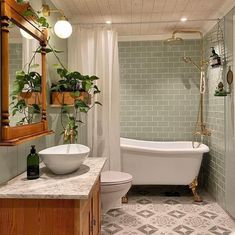 a bath room with a toilet a tub and a sink