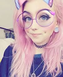 a woman with pink hair wearing glasses and cat ears