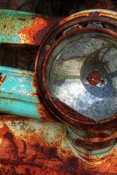 an old rusted out fire hydrant with the light on