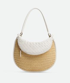 "Find BOTTEGA VENETA Medium Gemelli on Editorialist. Medium raffia crochet and Intrecciato leather shoulder bag. Tubular detachable handle. Additional half-moon zipped handle in Intrecciato leather. One internal zipped pocket. Zip closure. Lining: Canvas. Color: Natural/Chalk. Hardware: Brass finish. Height: 25 cm | 9.8\". Width: 36 cm | 14.2\". Depth: 10 cm | 3.9\". Handle drop: 26 cm | 10.2\". Viscose." Raffia Crochet, Crochet Shoulder Bag, Jewelry Knots, Leather Denim, Mini Crossbody, Long Wallet, Half Moon, Accessories Necklace, New Bag