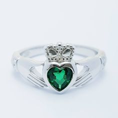 The perfect gift for you or someone close. Sterling silver claddagh ring set with emerald green heart shaped stone framed with white cubic zirconia in the cuffs. The hands represent friendship, the heart love and the crown stands for loyalty. This ring is made in solid sterling silver, to maintain the color as long as possible please avoid contact with chemicals, lotions etc and keep in an airtight zip lock bag when not being worn. ---------------------------------------------------- Features -- Silver Claddagh Ring, Zip Lock Bag, Claddagh Ring, Claddagh Rings, Green Heart, May Birthstone, Handmade Design, Green Fashion, Ring Set