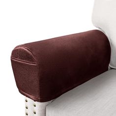 a close up of a pillow on the back of a couch with studded legs