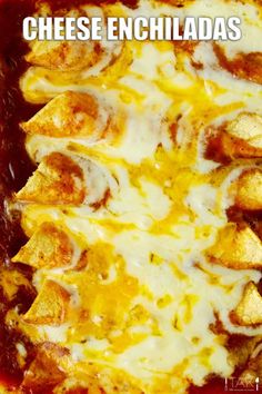 cheese enchiladas in a red casserole dish with melted cheese on top