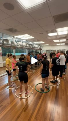 a group of people standing on top of wooden floors