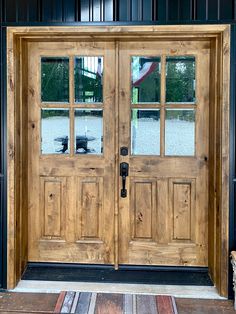 a wooden door with two sidelights and glass on the front entrance to a building