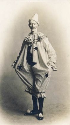 an old photo of a man dressed as a clown with stars on his pants and hat