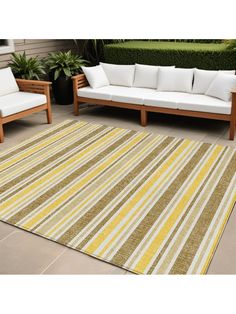 a striped rug on the ground next to two couches