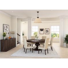 a dining room table with chairs and a rug on the floor