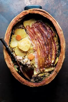 a wooden bowl filled with food on top of a table