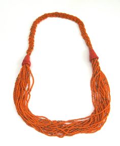 here is a wonderful  and bold orange statement glass beaded rope necklace from kenya,  africa.    the masai.    this measures about 28 inches in length.     although this is vintage,     it  still makes a bold statement.    so why not,    need a vintage gift ? Orange Multi-strand Hand-strung Jewelry, Traditional Orange Multi-strand Jewelry, Orange Hand-strung Multi-strand Jewelry, Orange Bohemian Hand-strung Beaded Necklace, Bohemian Fair Trade Orange Jewelry, Fair Trade Bohemian Orange Jewelry, Fair Trade Orange Bohemian Jewelry, Handmade Multi-strand Orange Beaded Necklaces, Traditional Orange Beaded Necklace With Gold Beads