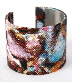 "This is a 2\" wide beaded image with a pallet of 192  colors of Miyuki 11/0 seed beads. I've always had an issue with the types of clasps to use with beads until I decided to go with an aluminum cuff. I LOVE THIS DESIGN! The silver reflection of the aluminum underneath the beads reflects with the transparent beads, giving it more depth. PLUS: easy to put on, easy to take off, one size fits all" Seed Bead Pattern, Lace Bracelet, Loom Pattern, Beaded Cuff Bracelet, Bead Loom, Beaded Cuff, Gold Lace, Bead Jewellery, Loom Beading