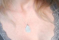 This sea glass and sterling silver necklace look elegant and effortless. We have hand drilled a genuine piece of sea glass, tumbled for years in the sand and salt water, and made it into a pendant. This pendant comes one an 18-inch sterling silver chain. A beautiful gift for yourself or someone you love. This is packaged in a reusable tin and can be sent as a gift with a complimentary message. Feel free to contact us with questions or special requests. Because we are using genuine sea glass, eac