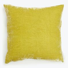 a yellow pillow on a white background