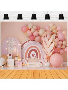 a room with balloons and decorations on the wall, including a large pink heart balloon