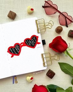 an open notebook with the word mr and mrs written on it next to red roses