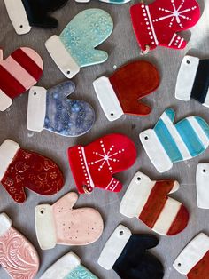 many different shaped cookies are on a table with snowflakes and mittens