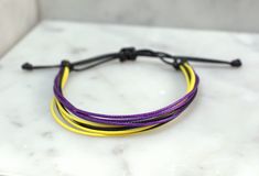 "Simple, yet stylish this waxed cord bracelet is 100% waterproof you can shower and swim with it on without taken it off. It is adjustable and fits size 5-9\" wrists. I have had my bracelets on since Mother's Day weekend and have never taken them off. They still look brand new! Style Incldues: *Black, Purple and Yellow(Other colors available) * Adjustable 5-9\" * Handmade in Minnesota by Flying Bird Jewelry * Cheap Shipping Color Options: * If you'd like to customize your bracelet colors select Pride Colours, Bracelet Colors, Wax Cord Bracelet, Jewelry Cheap, Mothers Day Weekend, Purple And Yellow, Bird Jewelry, Cord Bracelet, Cheap Jewelry