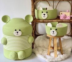 two green teddy bears sitting on stools next to baskets