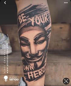 a person with a tattoo on their leg that says be your own hero, and an image of a guy's face