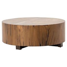 a round wooden table sitting on top of a white floor