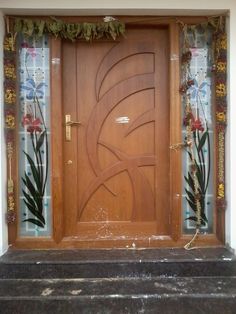 a wooden door with decorative glass panels on it