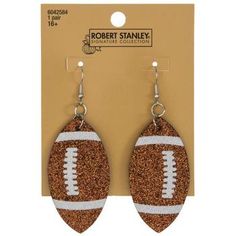 a pair of earrings with an image of a football on the front and back of it