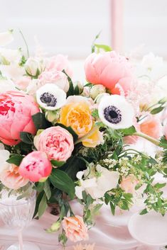 an arrangement of flowers on a table at a wedding