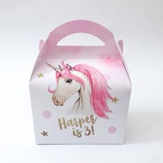 a pink and white box with a unicorn face on it's lid that says happy is 31