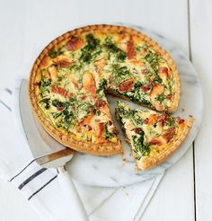 a quiche with spinach, bacon and cheese