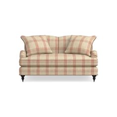 a plaid couch with two pillows on it's back and one arm facing the camera