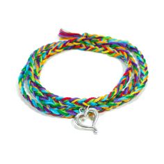 This rainbow wrap friendship bracelet has been paired with a sweet heart charm! It's perfect for a gift to someone you love, or to give to yourself as a reminder that you are loved. You can choose the rainbow bracelet shown or you can request your own custom colors.  The soft, high-quality cotton used is lightweight and colorfast so you can wear it non-stop. The charm is pewter and is not handmade. Our braided wraps are completely adjustable - you receive one long strand and you can knot anywher Casual Heart-shaped Friendship Bracelets, Casual Heart Charm Bracelet As Gift, Casual Heart Charm Bracelet For Gift, Casual Heart Charm Bracelet Gift, Adjustable Playful Heart Bracelet As Gift, Playful Friendship Bracelets With Heart Beads For Gift, Casual Heart Charm Jewelry For Friendship, Adjustable Friendship Bracelet With Heart Charm For Best Friend, Adjustable Heart-shaped Friendship Bracelets