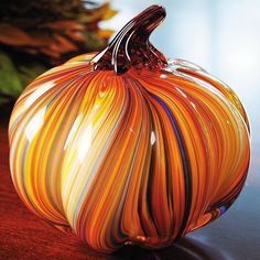 a glass pumpkin sitting on top of a table