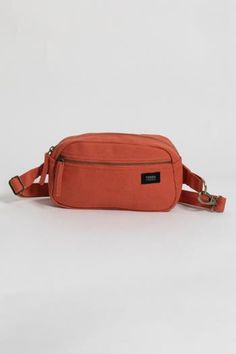 an orange fanny bag on a white background