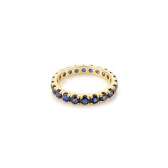 a yellow gold ring with blue sapphire stones