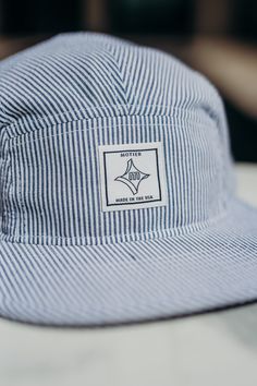 This Seersucker camp cap features a classic 5-panel design constructed from cotton twill, and a nylon woven strapback for adjustable comfort. This two-tone hat perfectly complements any outdoor outfit. Cotton Twill Nylon Woven Strapback 5 Panel Summer Cotton Baseball Cap With Adjustable Fit, Navy Adjustable Baseball Cap For Summer, Navy Adjustable 5-panel Baseball Cap, Navy Cotton Baseball Cap For Outdoor, Navy Adjustable Baseball Cap For Spring, Adjustable Fit Six-panel Baseball Cap For Summer, Curved Bill Baseball Cap For Summer Camping, Adjustable Cotton 5-panel Baseball Cap, Summer Six-panel Baseball Cap