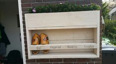 two pairs of yellow shoes are sitting on a shelf in front of a brick wall