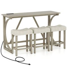 three stools and a table with an electric cord attached to the back rest area