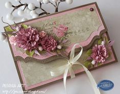 a close up of a card with flowers on it and a ribbon around the edge