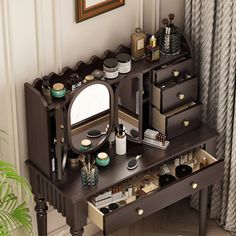 a wooden vanity with drawers and mirror on top of it next to a potted plant