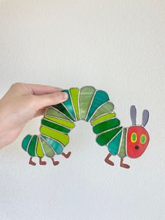 Inspired by Eric Carle's The Very Hungry Caterpillar! Stained glass sun catcher handmade art. Stained Glass Caterpillar, Hungry Caterpillar Art, Caterpillar Art, Stained Glass Sun, Panels Wall, Nursery Room Inspiration, Stained Glass Suncatchers, The Very Hungry Caterpillar, Stained Glass Panel