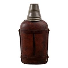 an old fashioned leather flask bottle with a metal cap on the top and bottom