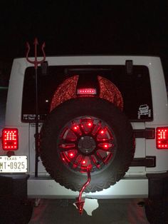 a white truck with red lights on it's tires