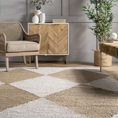 a living room with a chair, sideboard and potted plant