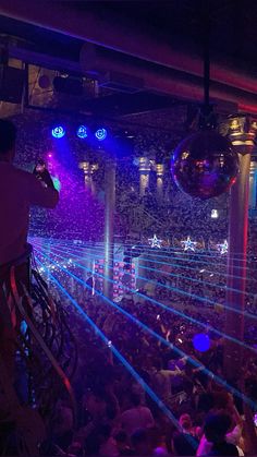 a man taking a photo of an audience at a concert