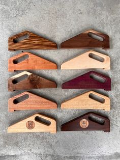 several wooden cutting boards with different shapes and sizes are arranged in a row on a concrete surface