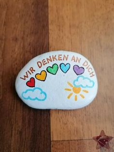 a painted rock with the words,'wir denken an dish'on it