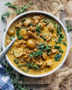 a white bowl filled with stew and potatoes