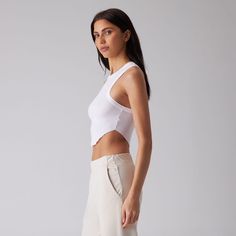 Not your average tank. Introducing the Scallop Tank. Cut from ultra-lightweight modal rib for the most comfortable fit and feel yet. Featuring a curved hem and racer back, this is the tank you're missing. 96% Modal, 4% Spandex Form Fitting Soft Ribbed Texture Crop Length Raw-Hem Scallop Hemline Racerback Shape White Summer Tank Top With Minimal Stretch, White Tank Top With Seamless Construction, White Tank Top With Minimal Stretch, White Tank Top With Minimal Stretch And Seamless Construction, Sporty Tank Top With Minimal Stretch, Slightly Stretchable Sleeveless Summer Crop Top, Summer Layering Tank Top With Minimal Stretch, Sporty Racerback Tops With Minimal Stretch, Spring Seamless Tank Top With Minimal Stretch