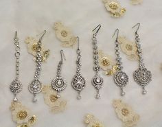 *silver CZ stone headpiece tikka. Light in weight. Silver Tikka For Wedding, Silver Hand Set Tikka For Celebration, Silver Hand Set Tikka For Wedding, Traditional Silver Tikka For Wedding, Silver Bridal Earrings With Stone Work For Reception, Elegant Silver Hand Set Tikka, Silver Jeweled Bridal Earrings For Celebration, Silver Tikka With Tilla For Celebration, Elegant Silver Tikka For Reception