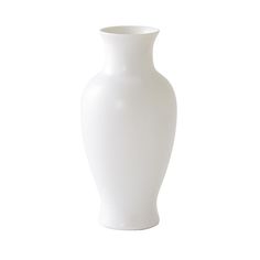 a white vase sitting on top of a table